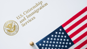 An American flag next to the seal and name of U.S. Citizenship and Immigration Services