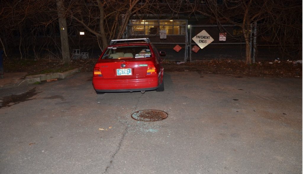 Vehicle parked next to dumpster that Daniels backed into, before driving onto the sidewalk. The glass in the photo is from Daniels’ vehicle, after the passenger-side window was smashed.