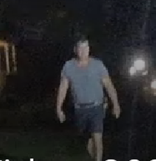  Schneider with cupped hands as he is walking toward police, ignoring commands.