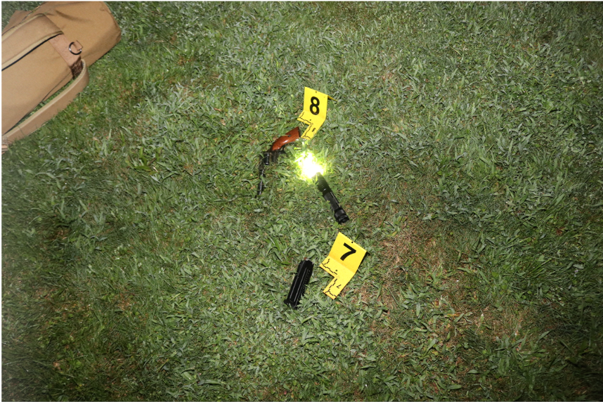 Gun, flashlight and ammunition found near and on Robert Schneider.