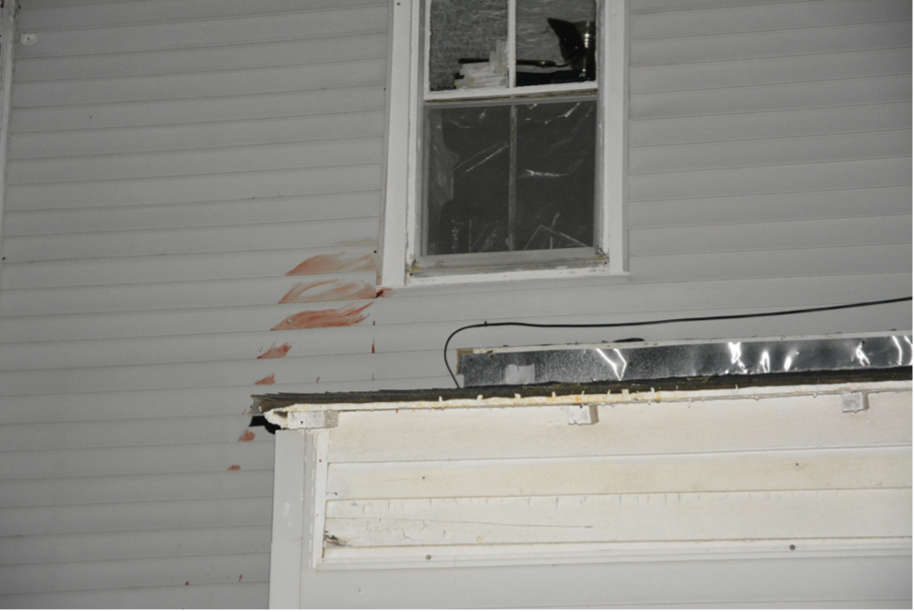 Photo showing blood on the siding as described by police.