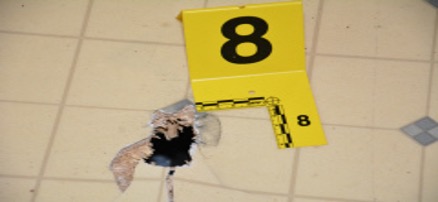 Damage to the floor caused by the shotgun round. 