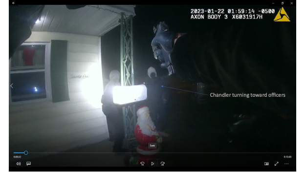 Body worn camera screenshot showing Chandler turning toward officers