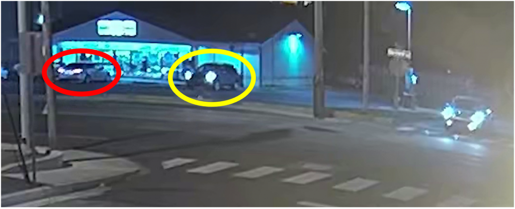 Figure 1. Still shot captured from surveillance footage of a business located across the street from the 7-Eleven. Depicted in the photograph is the parking lot of the South Maryland Avenue 7-11 with Officer Pala’s undercover vehicle (circled in red) and the Hyundai SUV driven by Edelmann (circled in yellow).